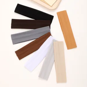 Close-up of thin elastic headbands in various solid colors for sports and yoga fitness.