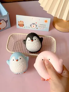 Hand squeezing a soft pink penguin squishy toy for stress relief and decompression