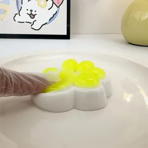 Detailed close-up view showing the soft texture of a yellow cat paw squishy stress relief toy