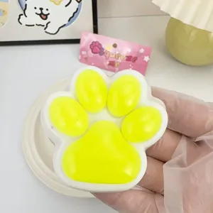 Close-up of a yellow cat paw slow rebound squishy toy held in hand for stress relief