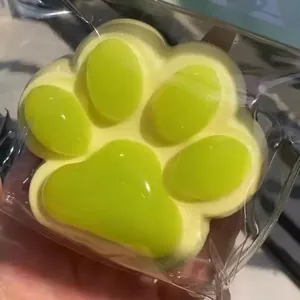 Cute cat paw squishy toy in lime green with grape-like translucent texture for stress relief