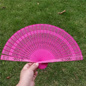Elegant hot pink hollowed-out wooden folding fan, perfect for classical weddings and gifts