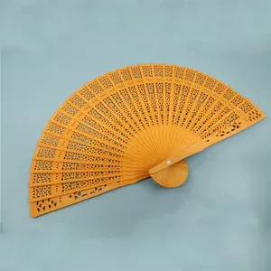 Elegant classical hollow-out folding wooden fan for women in vibrant orange color