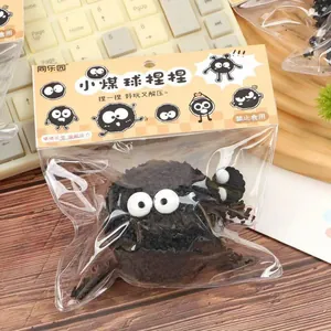 Macro detail of a black Soot Sprite squishy stress relief toy in its retail packaging.