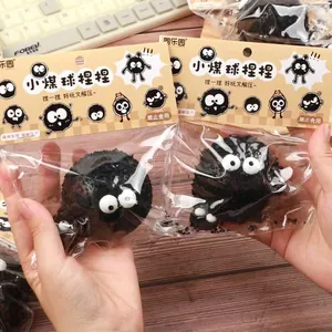 Detailed shot of two black Soot Sprite squishy toys in their retail packaging
