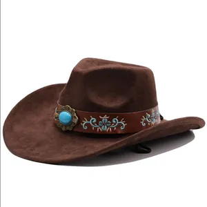Close-up of brown suede cowboy hat with turquoise-style stone and blue floral embroidery