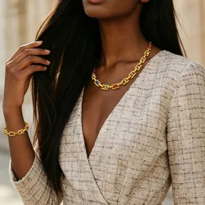Elegant gold-plated chain necklace and bracelet set with colorful gemstone accents on model