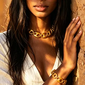 Detailed shot of a gold coffee bean link necklace and bracelet set on a model