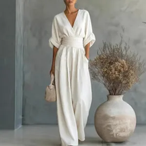 Elegant white wide-leg jumpsuit with deep V-neck and cinched waist in French style
