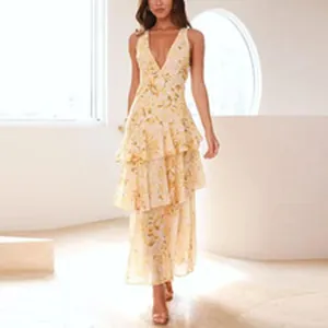 Detailed view of elegant yellow floral tiered maxi dress with deep V-neck design