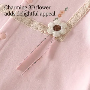 Detailed view of soft pink cotton baby girl romper with 3D flower and lace trim decoration
