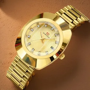 Close-up of a women's vintage gold quartz watch with a textured dial and alloy bracelet.