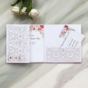 Detailed laser-cut wedding invitation with elegant floral patterns and watercolor prints.