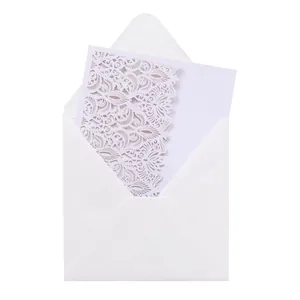 Elegant laser-cut white wedding invitation card with intricate lace floral carvings