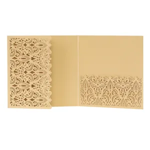 Intricate laser-cut floral pattern on a gold-toned kraft paper invitation card