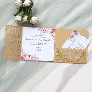 Close-up view of elegant laser-cut gold wedding invitation with floral printed cards