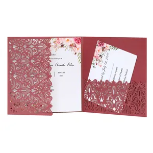 Detail view of burgundy laser-cut floral pattern wedding invitation card floral