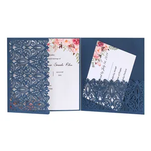 Detailed view of the navy blue laser-cut wedding invitation featuring floral inner cards