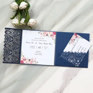 Elegant laser-cut navy blue wedding invitation with floral printed inner card detail.