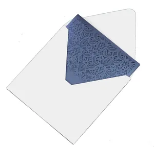 Detailed macro view of an elegant laser-cut dark blue wedding invitation in an envelope.