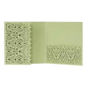Elegant detail of sage green laser-cut floral pattern on a wedding invitation card