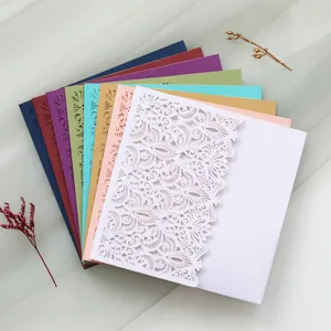 Detailed view showing intricate floral laser-cut patterns on colorful wedding invitation cards