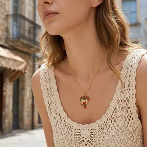 Festive candy cane necklace with bow detail worn by a model in a sunny outdoor street setting