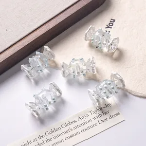 Macro view of clear candy-shaped hand-painted beads for DIY jewelry making projects