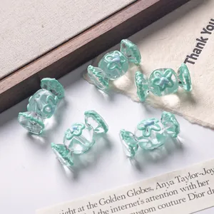 Macro view of candy-shaped mint green transparent beads for DIY jewelry and crafts
