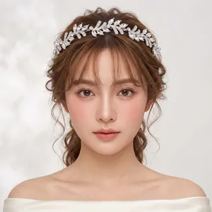 Elegant silver bridal crystal leaf headband shown on an Asian bride model for wedding.