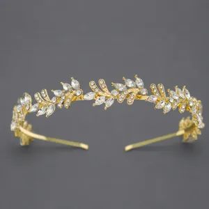 Elegant gold leaf bridal headband with sparkling rhinestones for wedding.