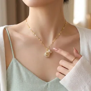 Elegant gold money bag necklace with crystals for women on Asian model
