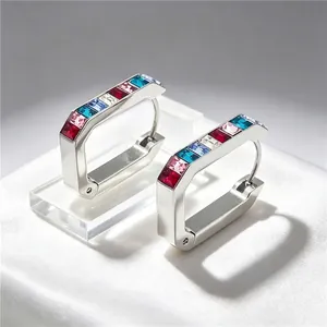 Close-up of stainless steel U-shape hoop earrings with multi-color cubic zirconia.