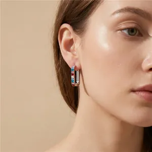 Close-up of model wearing stainless steel U-shaped earrings with colorful zircon