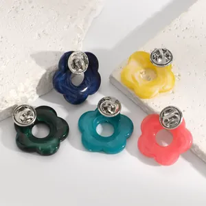 Detailed back view of colorful resin hollow flower brooches for hanging glasses.
