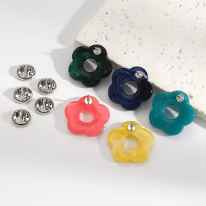Macro detail of colorful marbled resin flower brooches used as eyeglass holders.