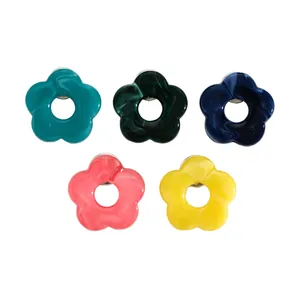 Set of five marbled resin flower brooches designed as eyeglass holders in various colors.