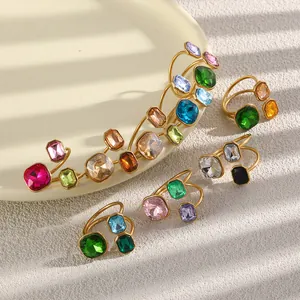 18K gold plated stainless steel open rings with colorful geometric crystals on white plate