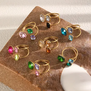 Collection of colorful geometric crystal open rings in 18K gold plated stainless steel.