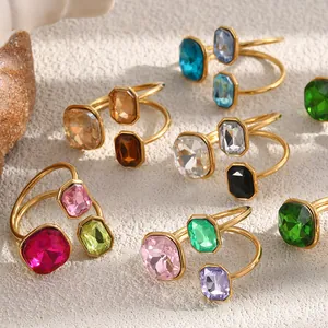 Detailed macro view of colorful geometric crystal rings in 18K gold plated stainless steel.