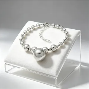 Detailed macro shot of a polished silver titanium steel ball bead bracelet