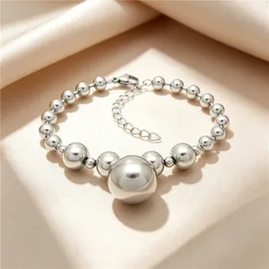 Close-up of silver titanium steel beaded bracelet with central large ball pendant