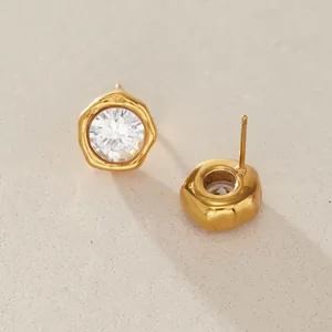 Detail view of gold-plated stainless steel stud earrings with clear round cubic zirconia