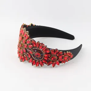 Detailed view of red rhinestone floral patterns on a vintage Baroque wide headband