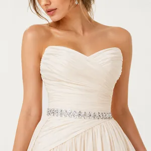Close-up of elegant handmade bridal belt with sparkling rhinestones on dress