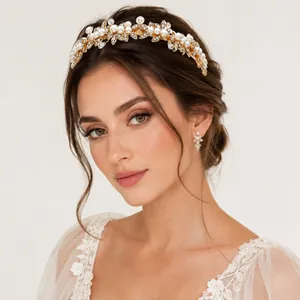 Close-up of elegant bridal headband with pearls, rhinestones and golden leaf design
