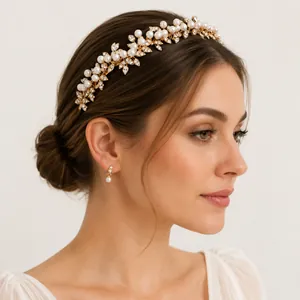 Detailed view of elegant gold bridal headband with pearls and rhinestones on a model
