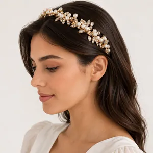 Luxury bridal headband with white pearls and sparkling rhinestones on gold leaves.