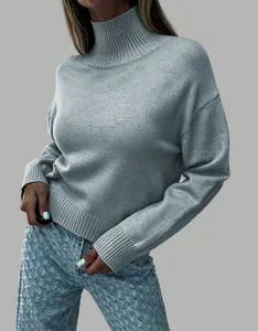 Close-up detail of a soft grey turtleneck knit sweater with drop shoulder design