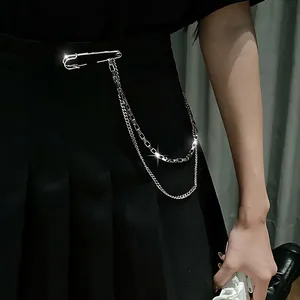 Detail of silver hip-hop waist chain with safety pin and multilayer links on black skirt